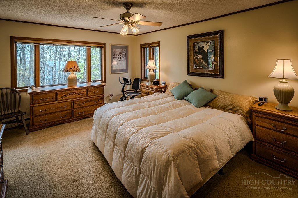 103-105 Upper Grouse Ridge Road Beech Mountain, NC 28604 - Photo 20 of 48 a bedroom with bed and window