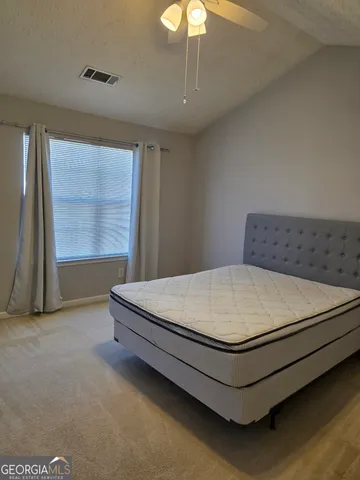 a bed sitting in a room next to a window