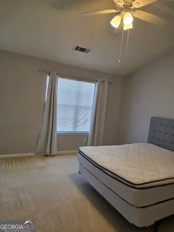 an empty room with a empty space and windows