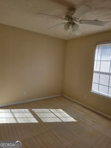 a view of an empty room with a fireplace