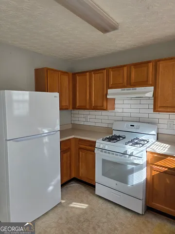 a white refrigerator freezer sitting inside of a kitchen
