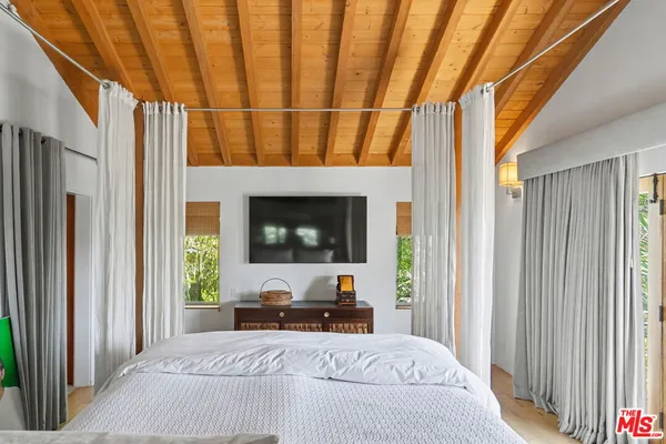 a room with a bed and a mirror