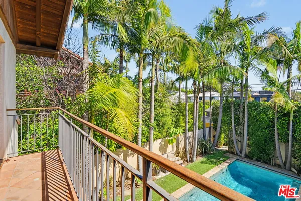 a bathroom with a double vanity sink a mirror and next to a window