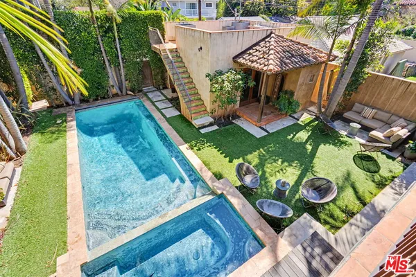 a en suite bathroom with a double vanity sink and a mirror