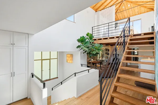 a bedroom with a bed and a potted plant