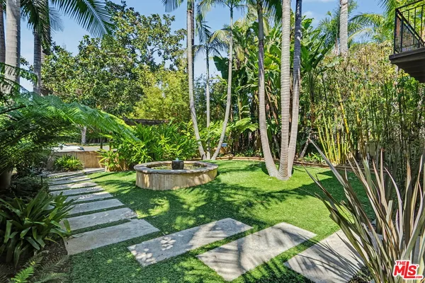a view of a dining table and chairs in the patio with a yard