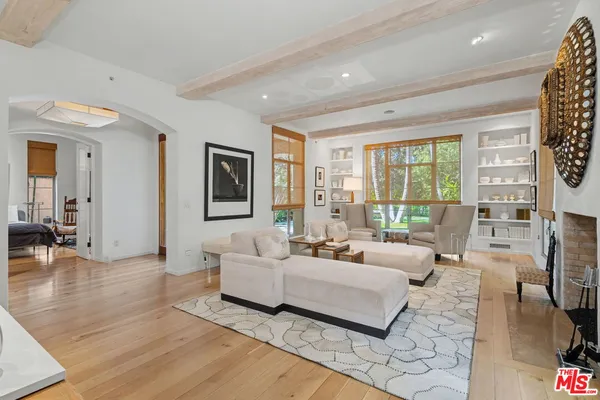 a living room with furniture wooden floor and a potted plant