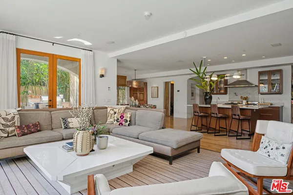 a living room with furniture large window and flat screen tv