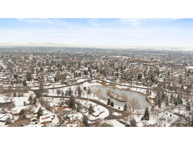 an aerial view of residential building and trees around