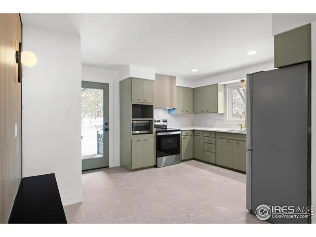 a kitchen with a refrigerator and a sink