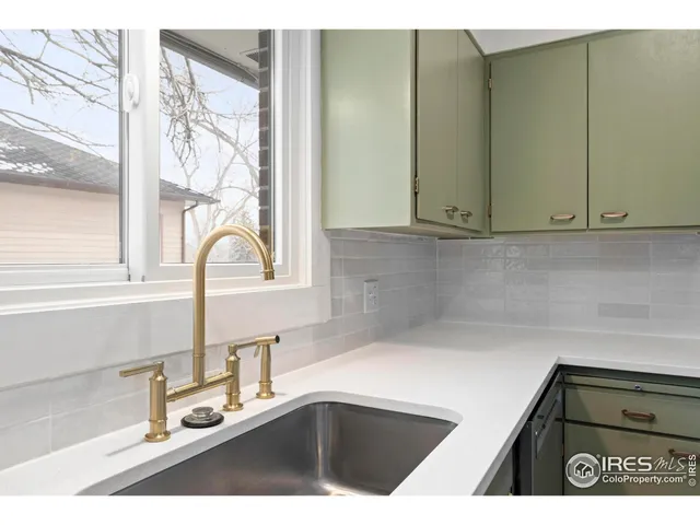 a kitchen with a sink and a window