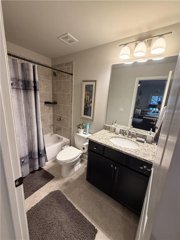3151 Osborne Road Northeast Brookhaven, GA 30319 - Photo 40 of 54 a spacious bathroom with a granite countertop sink toilet a mirror a vanity and shower