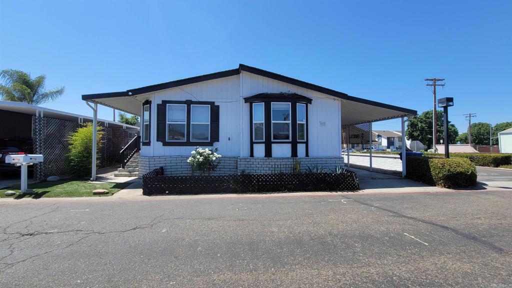 400 Greenfield Drive, Unit 1 El Cajon, CA 92021 - Photo 1 of 30 a front view of a house with a yard and outdoor seating