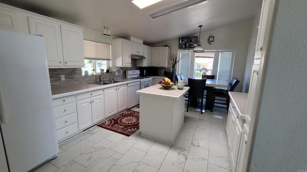 400 Greenfield Drive, Unit 1 El Cajon, CA 92021 - Photo 13 of 30 a kitchen with a sink cabinets and window
