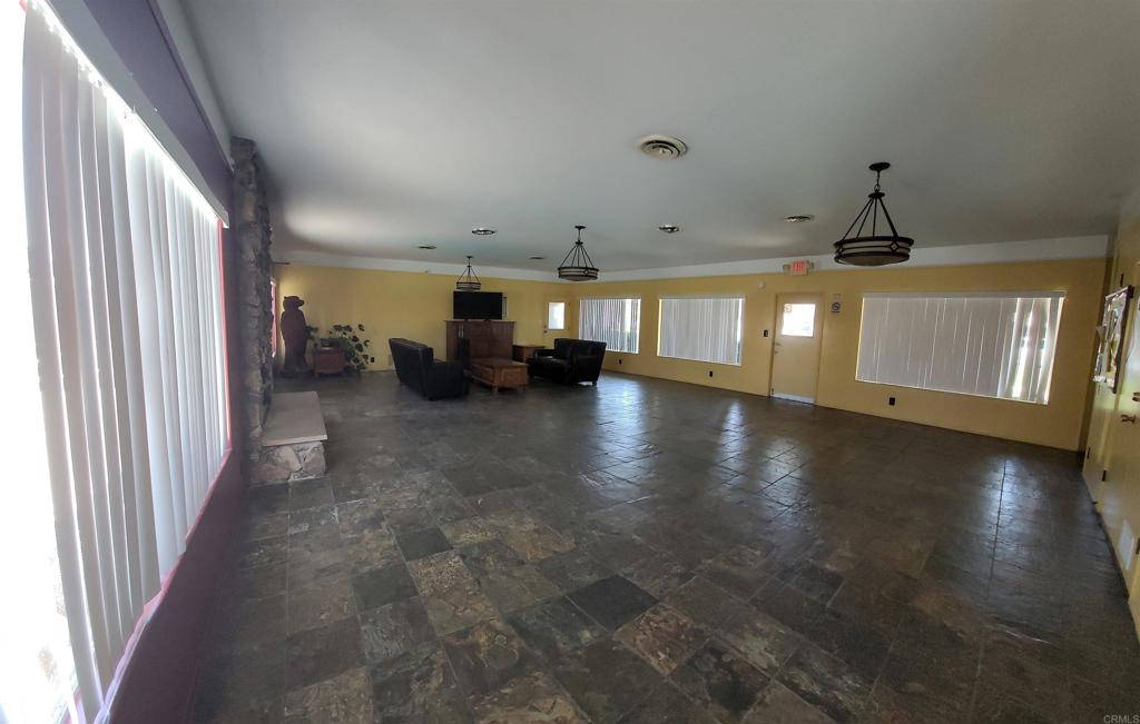 400 Greenfield Drive, Unit 1 El Cajon, CA 92021 - Photo 29 of 30 a view of a livingroom with furniture an entryway and fireplace