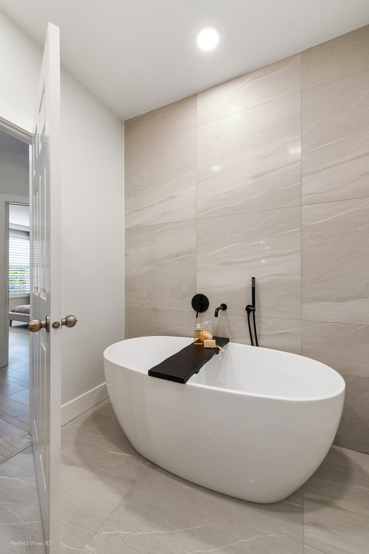 10200 Mulberry Lane, Unit G Bridgeview, IL 60455 - Photo 19 of 22 a bathroom with a bathtub and a shower