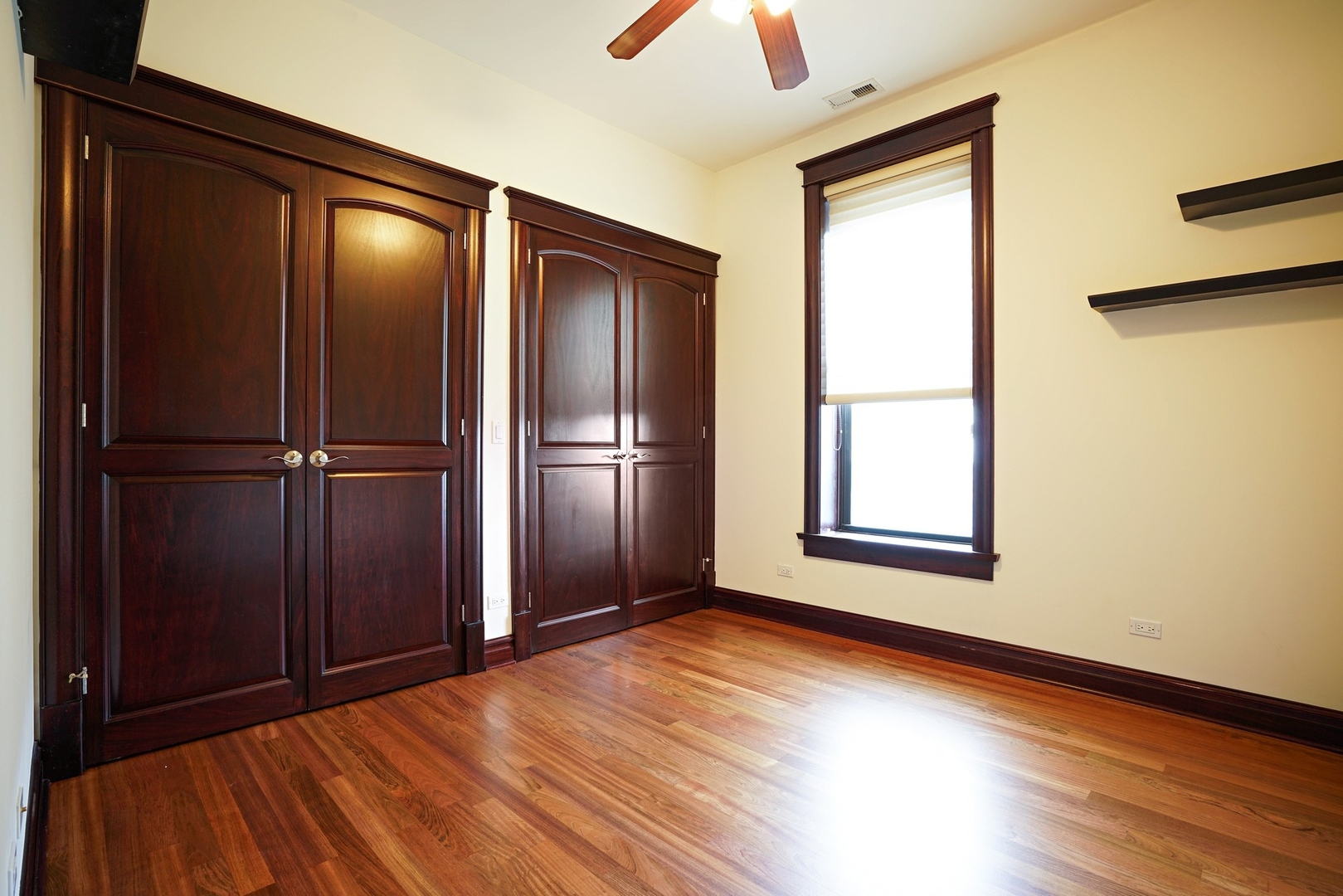 1416 West Superior Street, Unit 3F Chicago, IL 60642 - Photo 7 of 11 a view of an empty room with wooden floor and a window