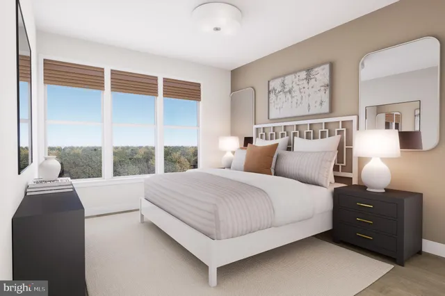 a bedroom with a large bed and a large window