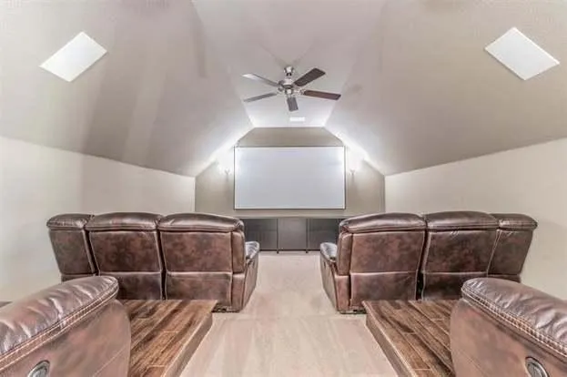 a room with a couch and a chandelier fan