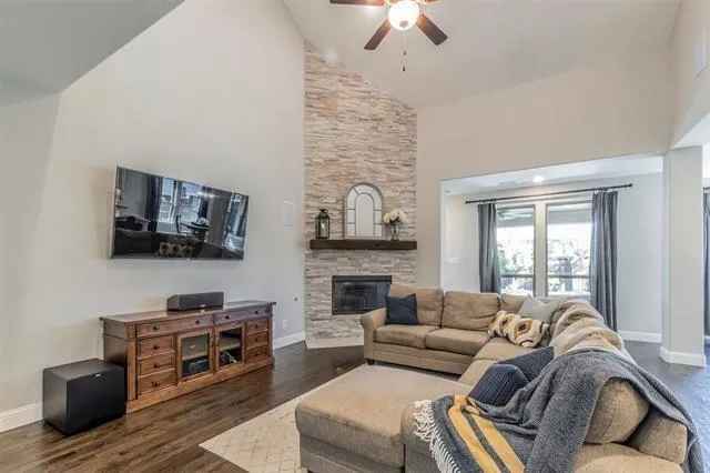 a living room with furniture a flat screen tv and a fireplace