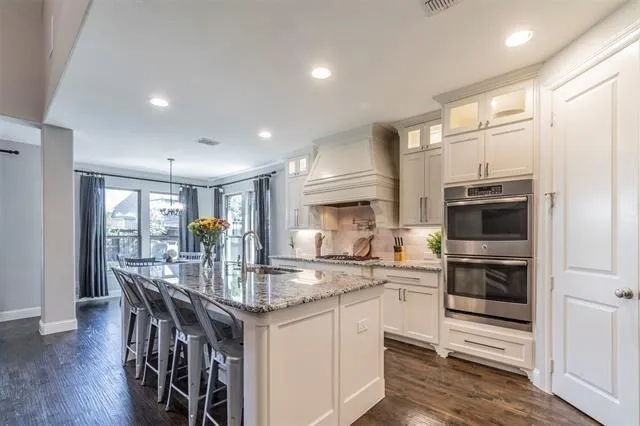 a kitchen with stainless steel appliances granite countertop a stove and a refrigerator