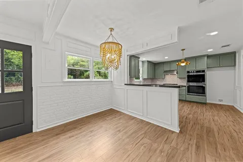 a view of a kitchen with a sink a refrigerator and window
