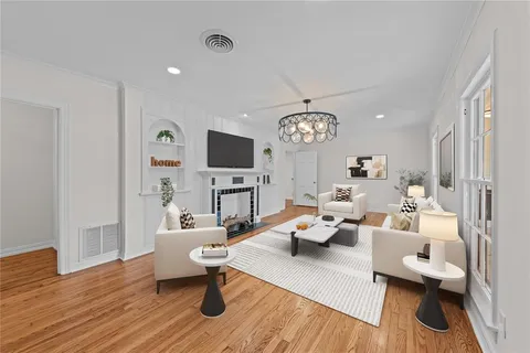 a living room with furniture a fireplace and a flat screen tv