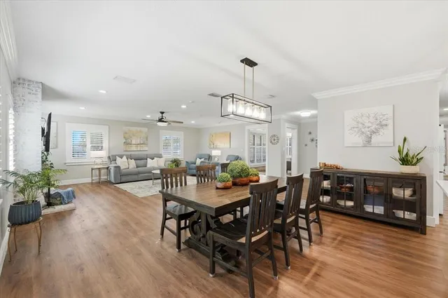a spacious bedroom with a bed and a large window with wooden floor