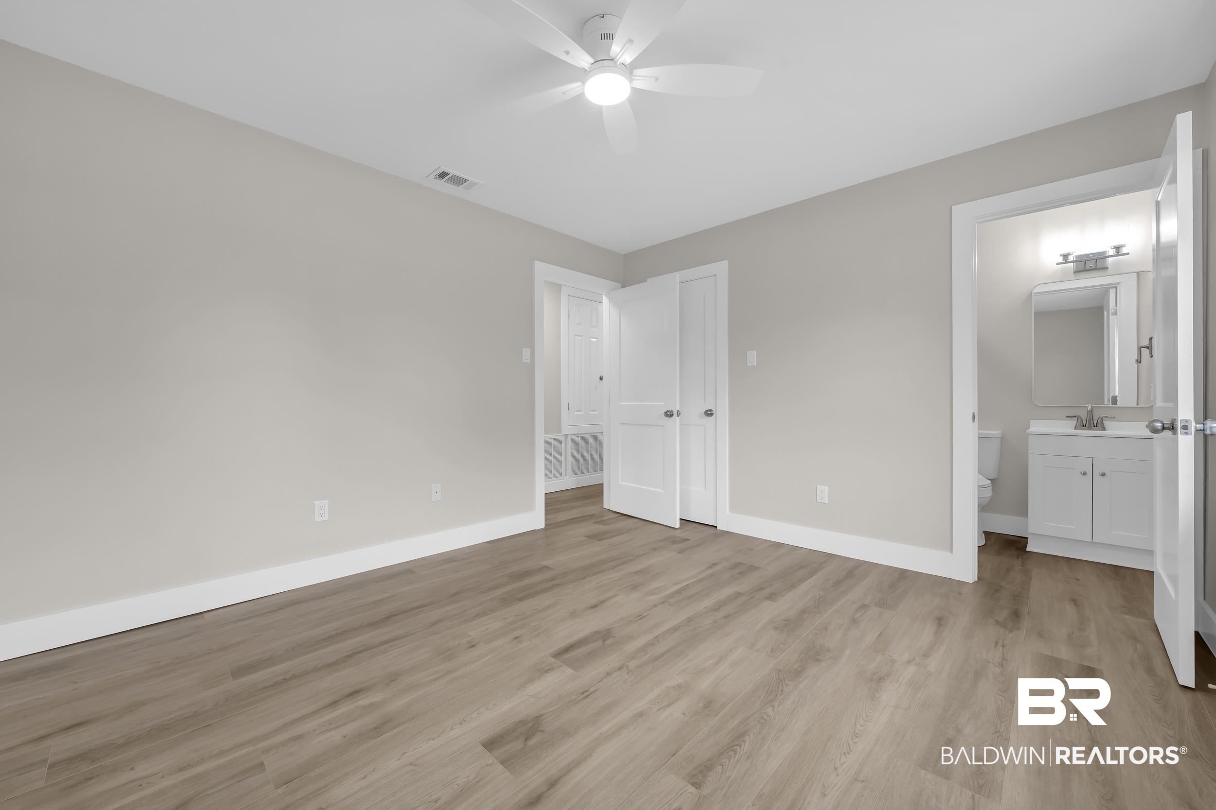 11381 Normandy Drive East Semmes, AL 36575 - Photo 15 of 23 Unfurnished bedroom featuring ensuite bath, light wood finished floors, and a ceiling fan