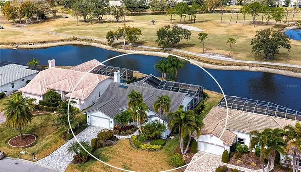 an aerial view of a house with outdoor space and a lake view