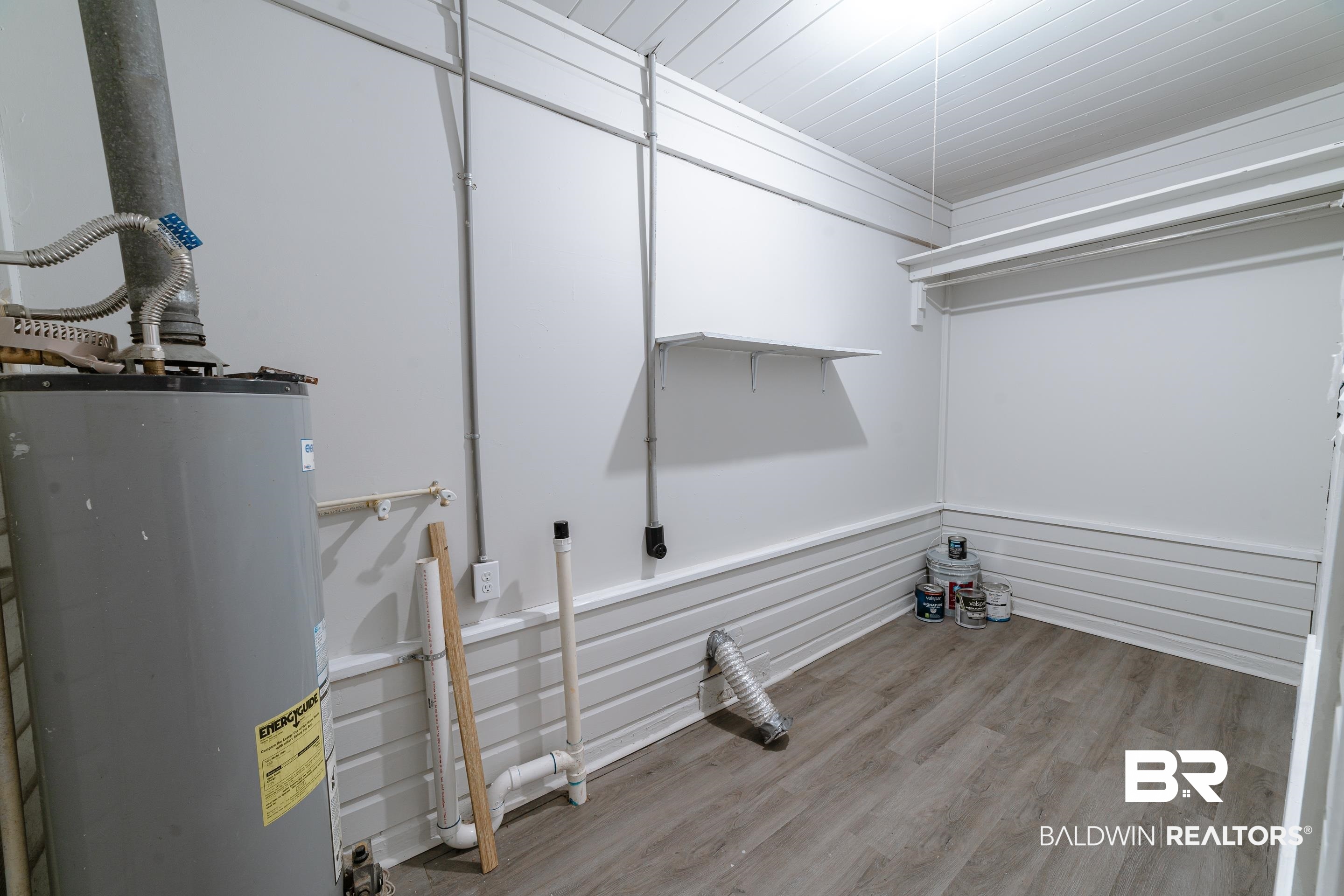 312 1st Street Mobile, AL 36611 - Photo 22 of 29 Clothes washing area featuring electric water heater and light hardwood / wood-style flooring