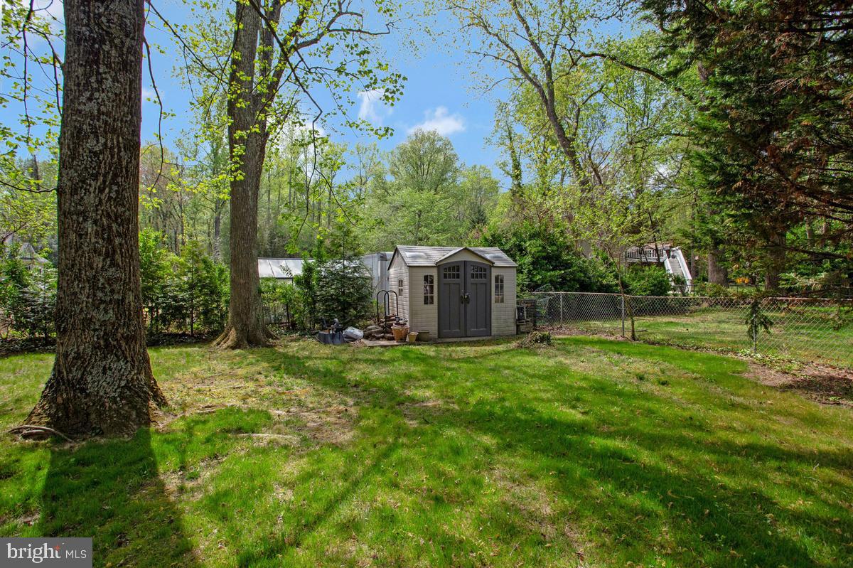 91 Scotts Cove Road Edgewater, MD 21037 - Photo 38 of 40 Charming backyard with a cozy shed.
