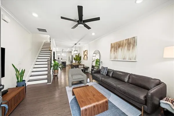 a living room with furniture and wooden floor