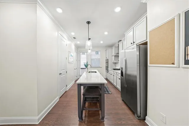 a kitchen with stainless steel appliances a refrigerator and a stove