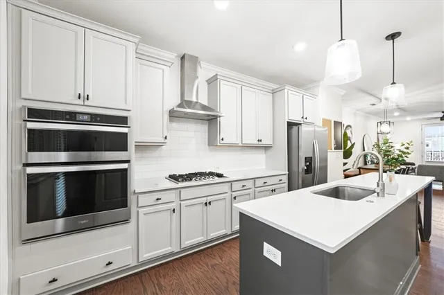 a kitchen with stainless steel appliances white cabinets and white appliances