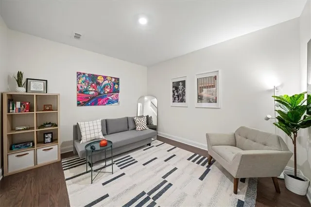 a living room with furniture and a bookshelf