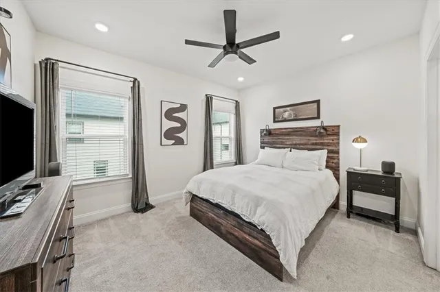 a bedroom with a bed window and a flat screen tv