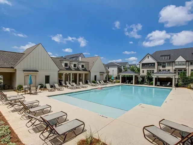 a view of a house with pool patio and outdoor seating