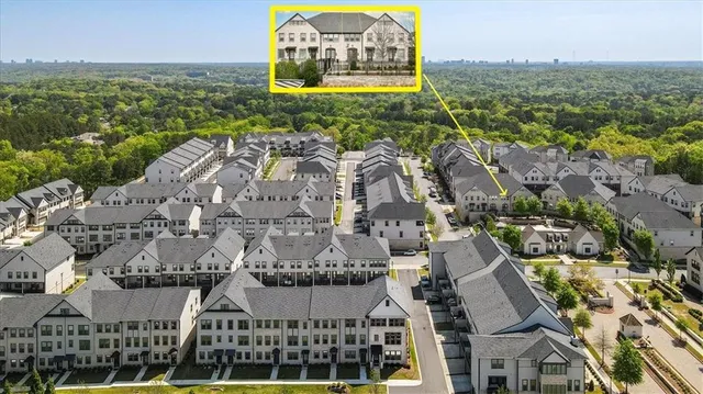 an aerial view of a residential building with an ocean view