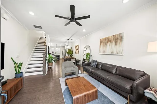 a living room with furniture and wooden floor