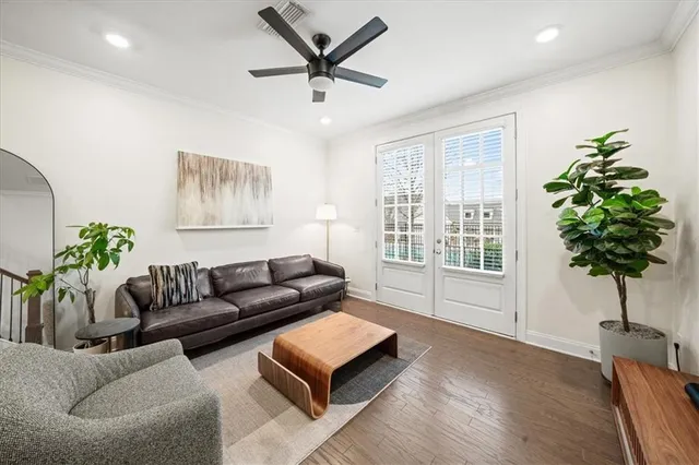 a living room with furniture and a potted plant