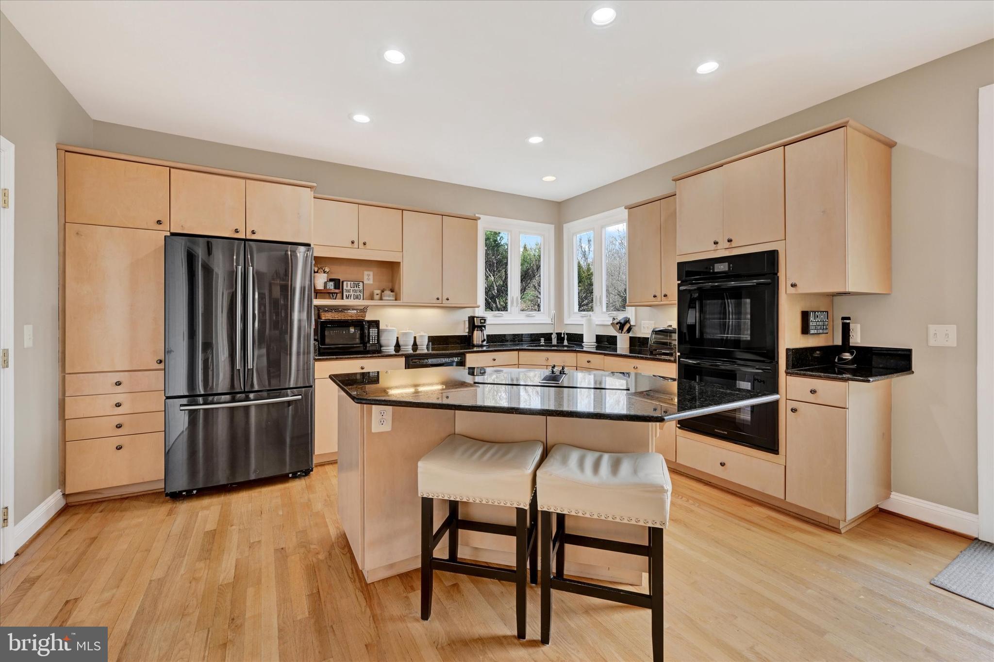 9 Liberty Ridge Court Reisterstown, MD 21136 - Photo 11 of 42 a kitchen with granite countertop a refrigerator stove microwave and cabinets