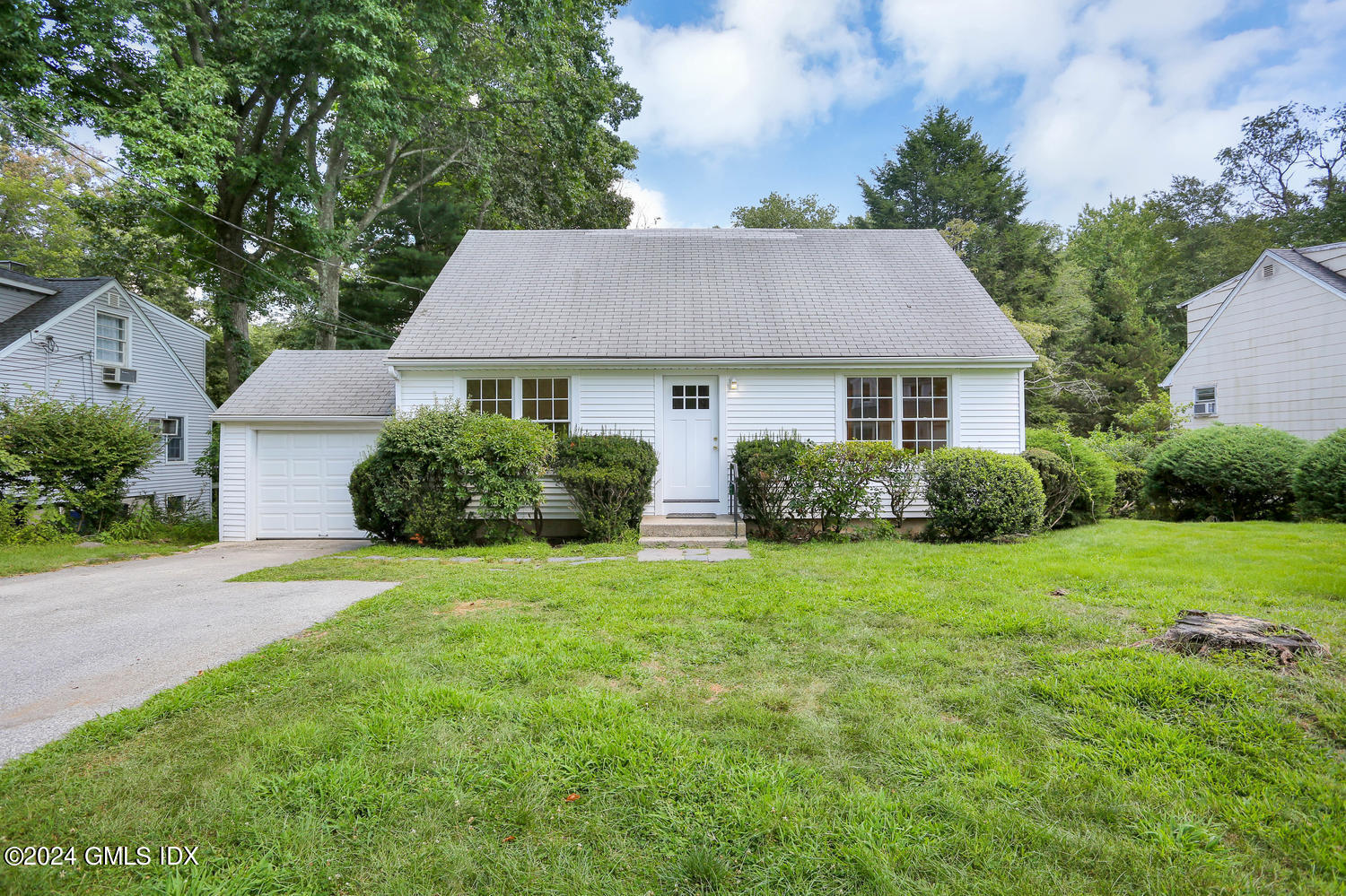 a front view of house with yard and green space