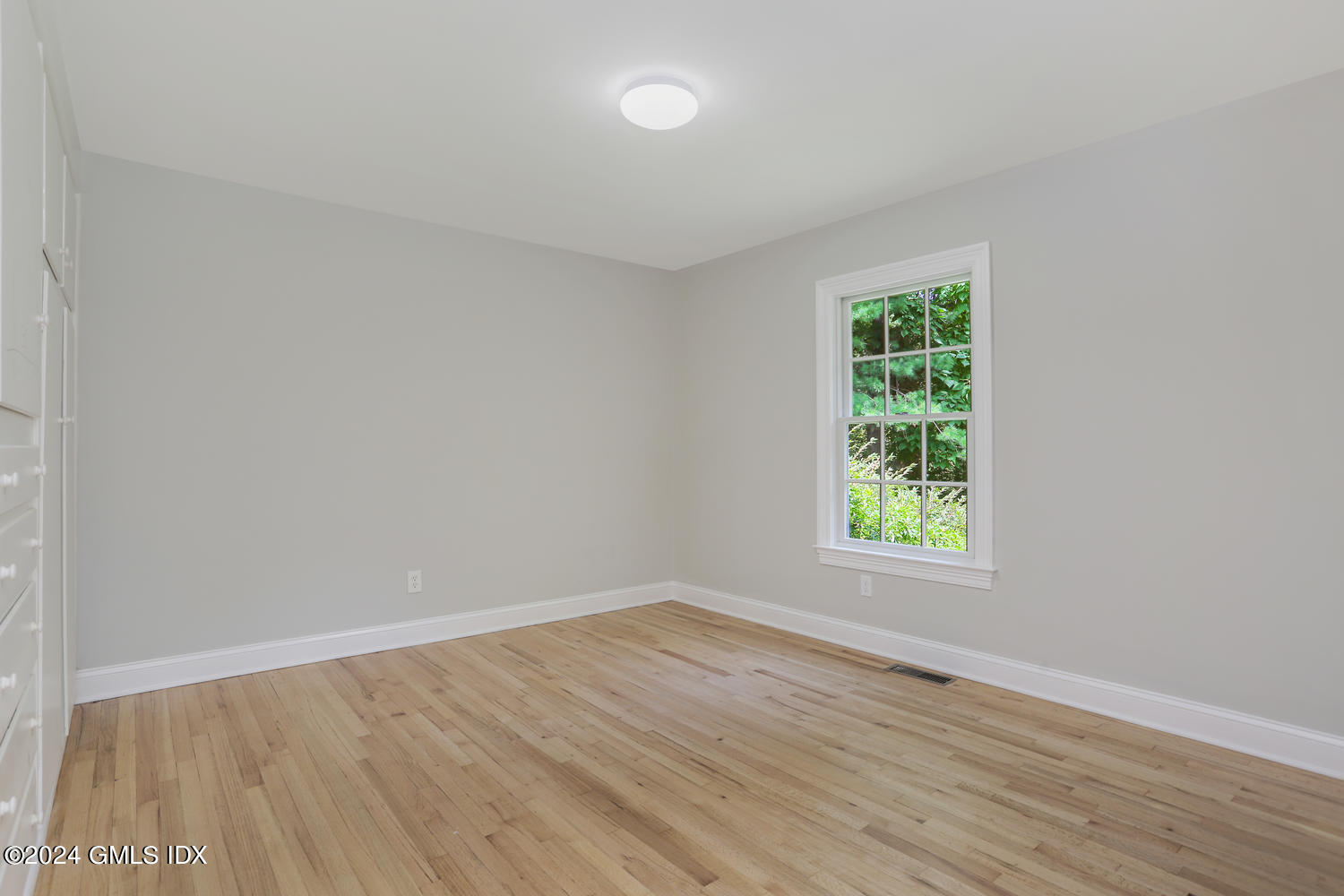 10 Florence Road Riverside, CT 06878 - Photo 6 of 14 an empty room with wooden floor and windows