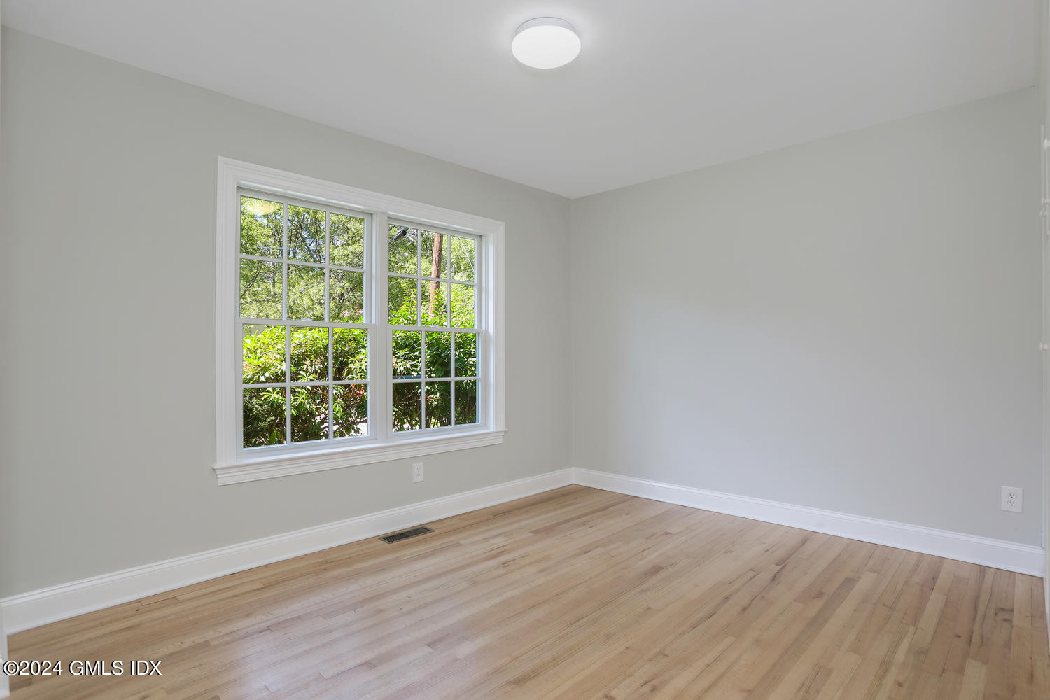 10 Florence Road Riverside, CT 06878 - Photo 7 of 14 a view of an empty room with wooden floor and a window
