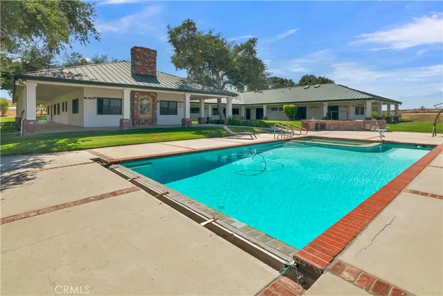 a front view of a house with swimming pool and porch