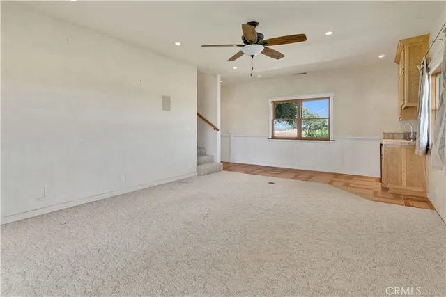 an aerial view of a house with yard