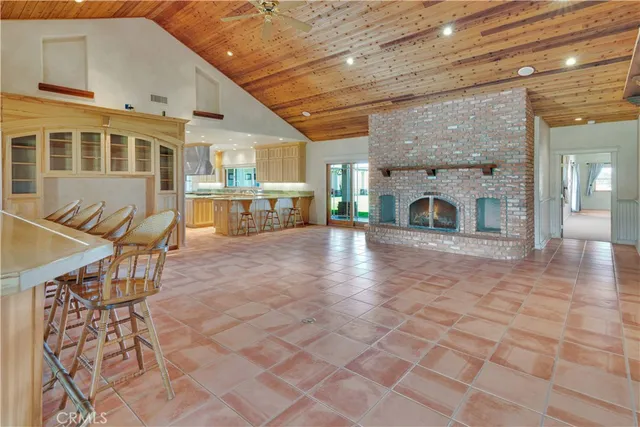 a bathroom with a granite countertop toilet sink and mirror
