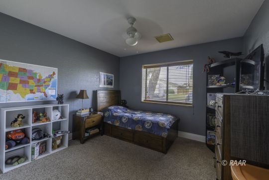 815 James Street Ridgecrest, CA 93555 - Photo 13 of 27 a bedroom with bed and a window