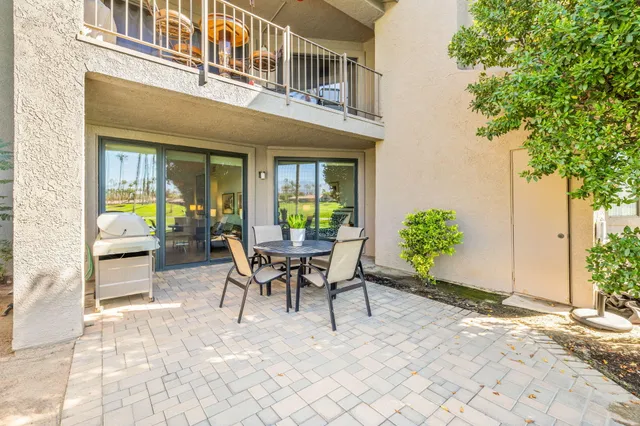 a view of a house with swimming pool and next to a yard